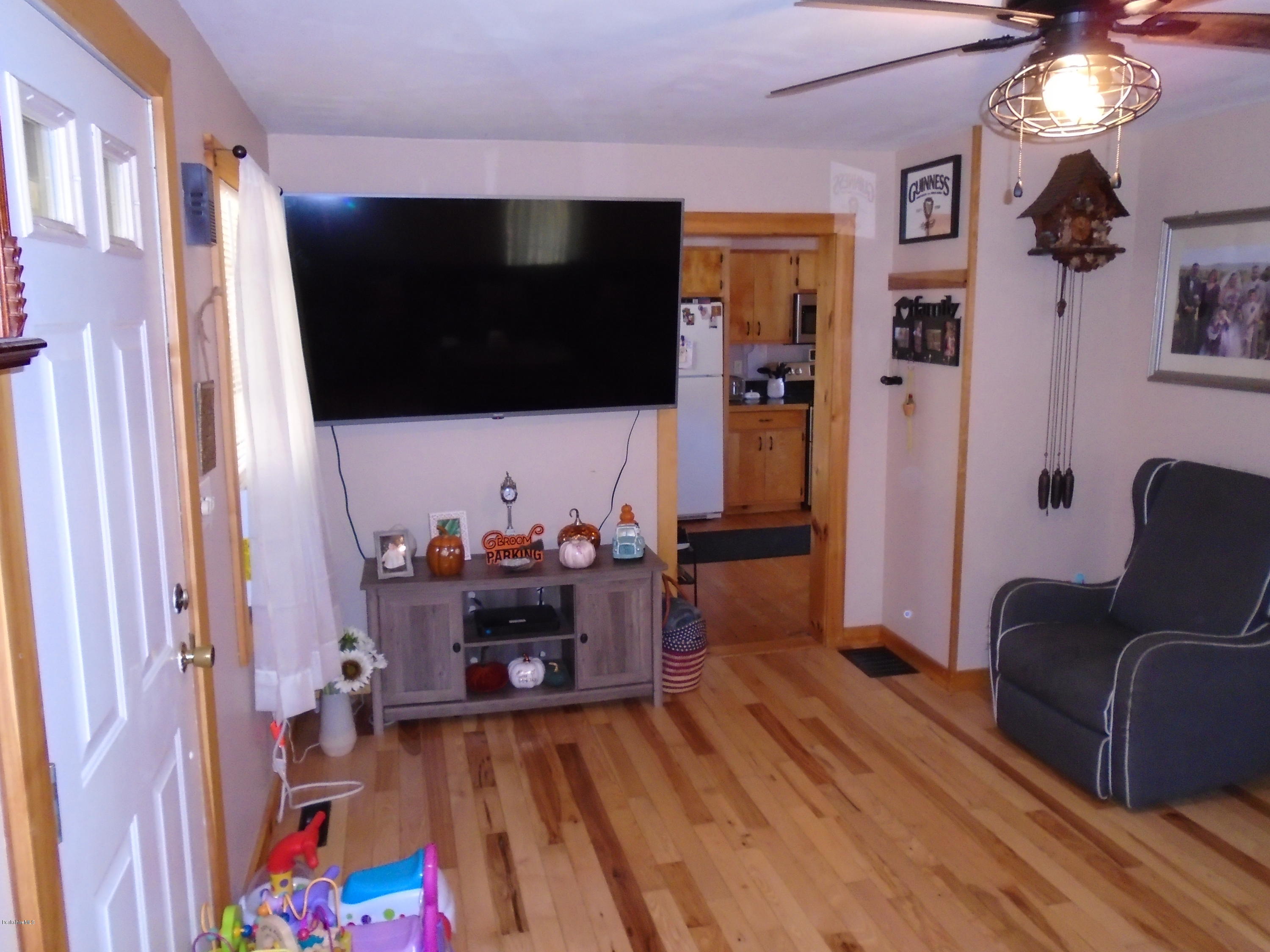 4 River Road Savoy, MA 01256 - Photo 16 of 39 a living room with furniture and a flat screen tv