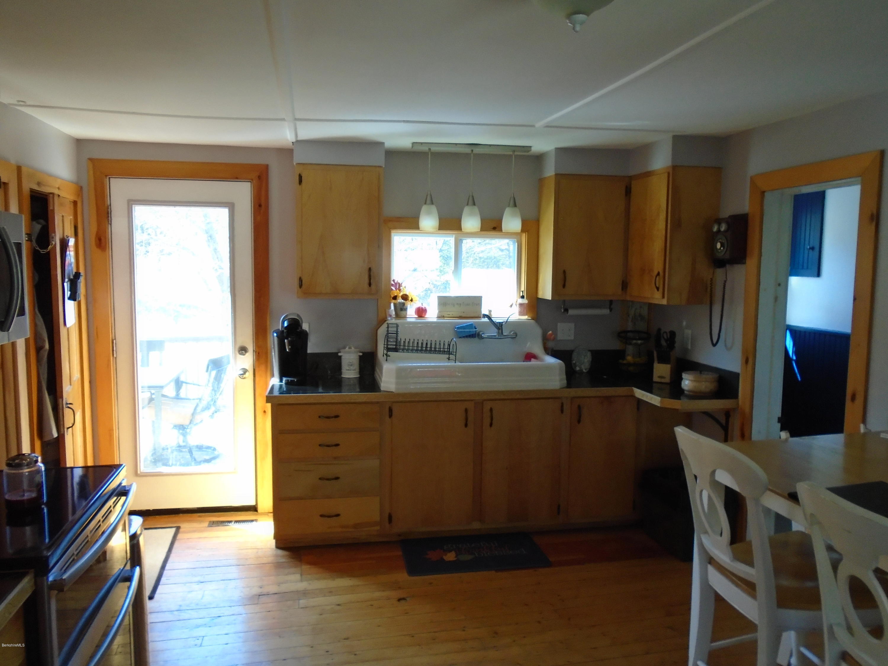 4 River Road Savoy, MA 01256 - Photo 21 of 39 a living room with furniture a large window and wooden floor
