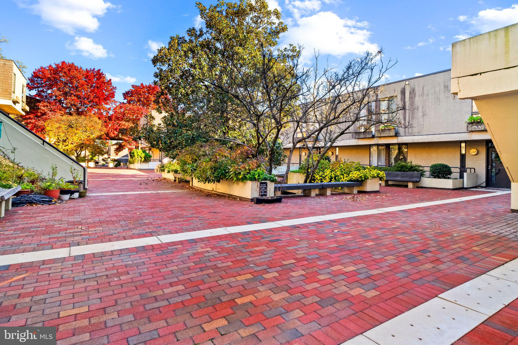 2363 Nutmeg Terrace Baltimore, MD 21209 - Photo 26 of 29 a view of road with card parked on side and retail shops