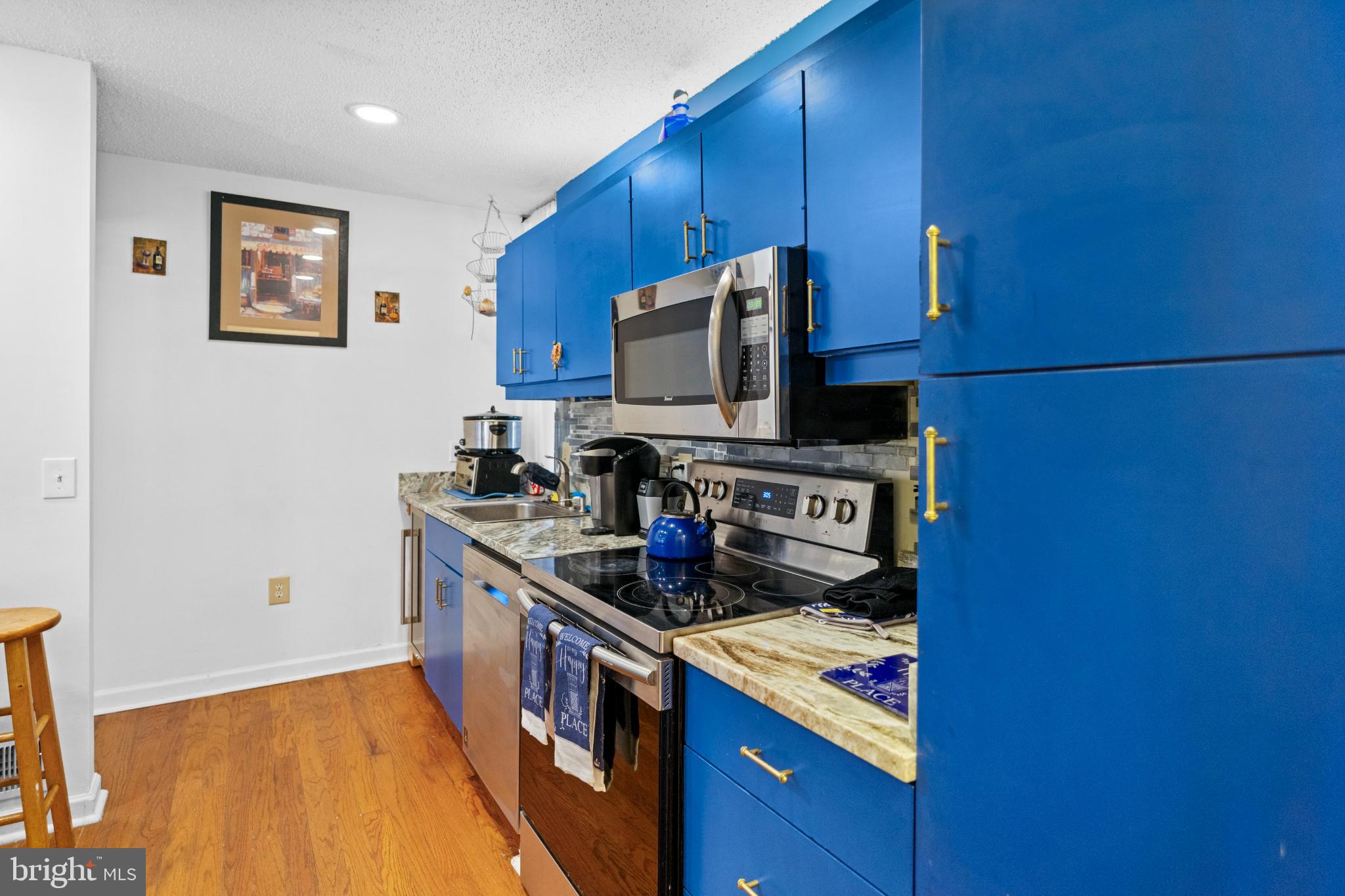 2363 Nutmeg Terrace Baltimore, MD 21209 - Photo 5 of 29 a kitchen with stainless steel appliances granite countertop a stove and a microwave