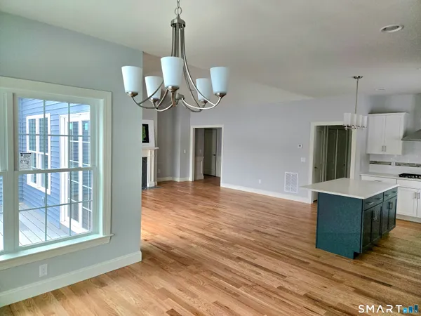 a kitchen with stainless steel appliances a refrigerator and a wooden floor
