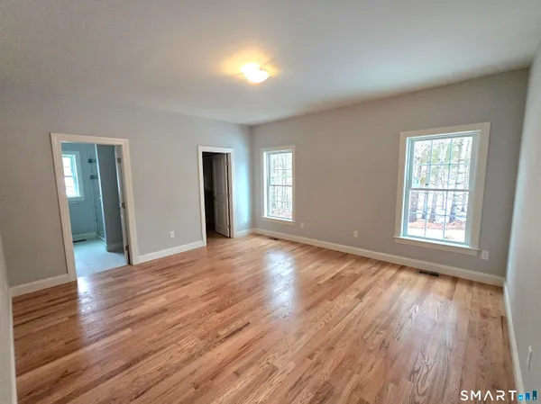 a bathroom with a double vanity sink a toilet and a mirror
