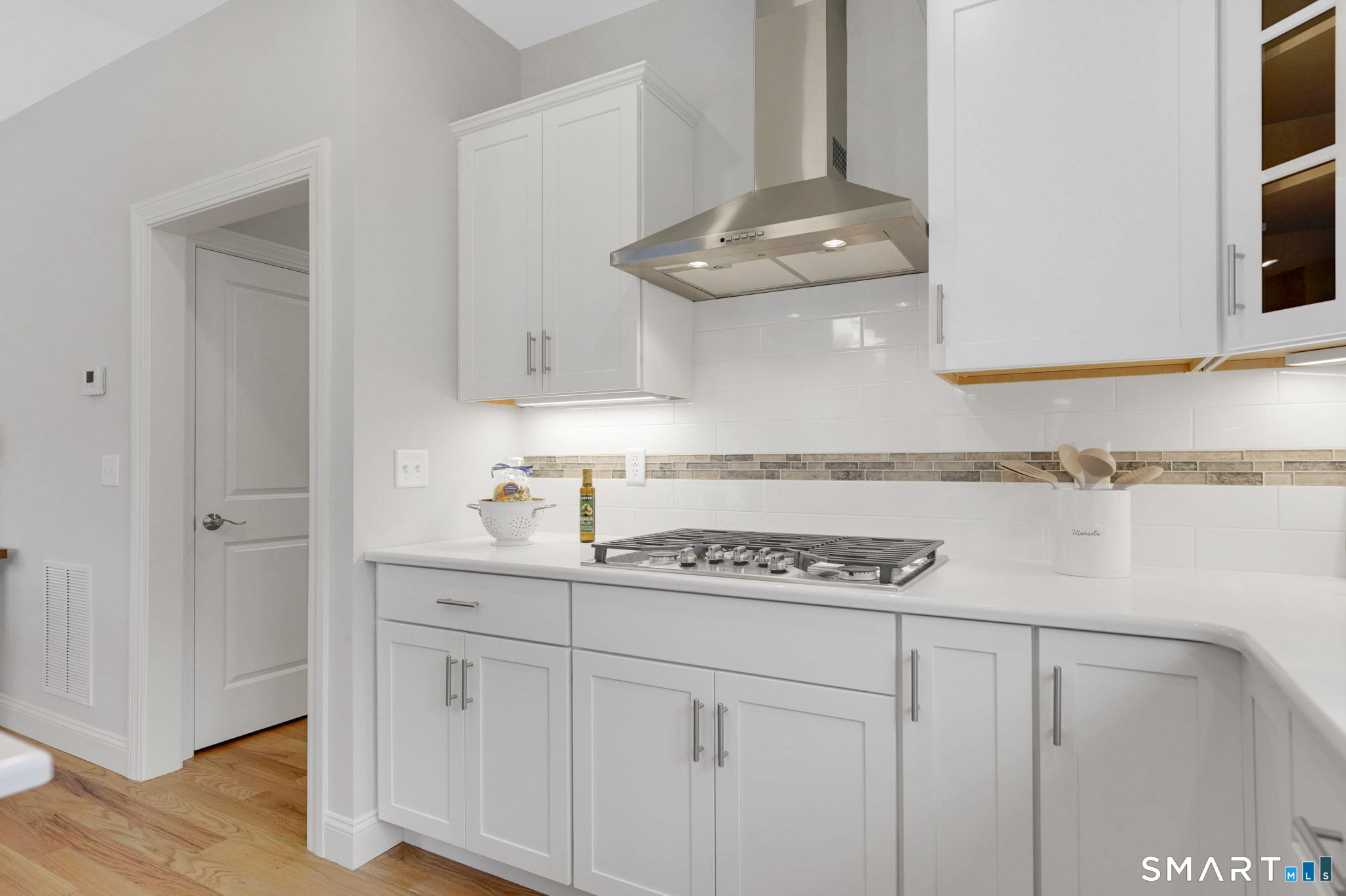 60 Liberty Lane Enfield, CT 06082 - Photo 17 of 38 a kitchen with cabinets and chandelier