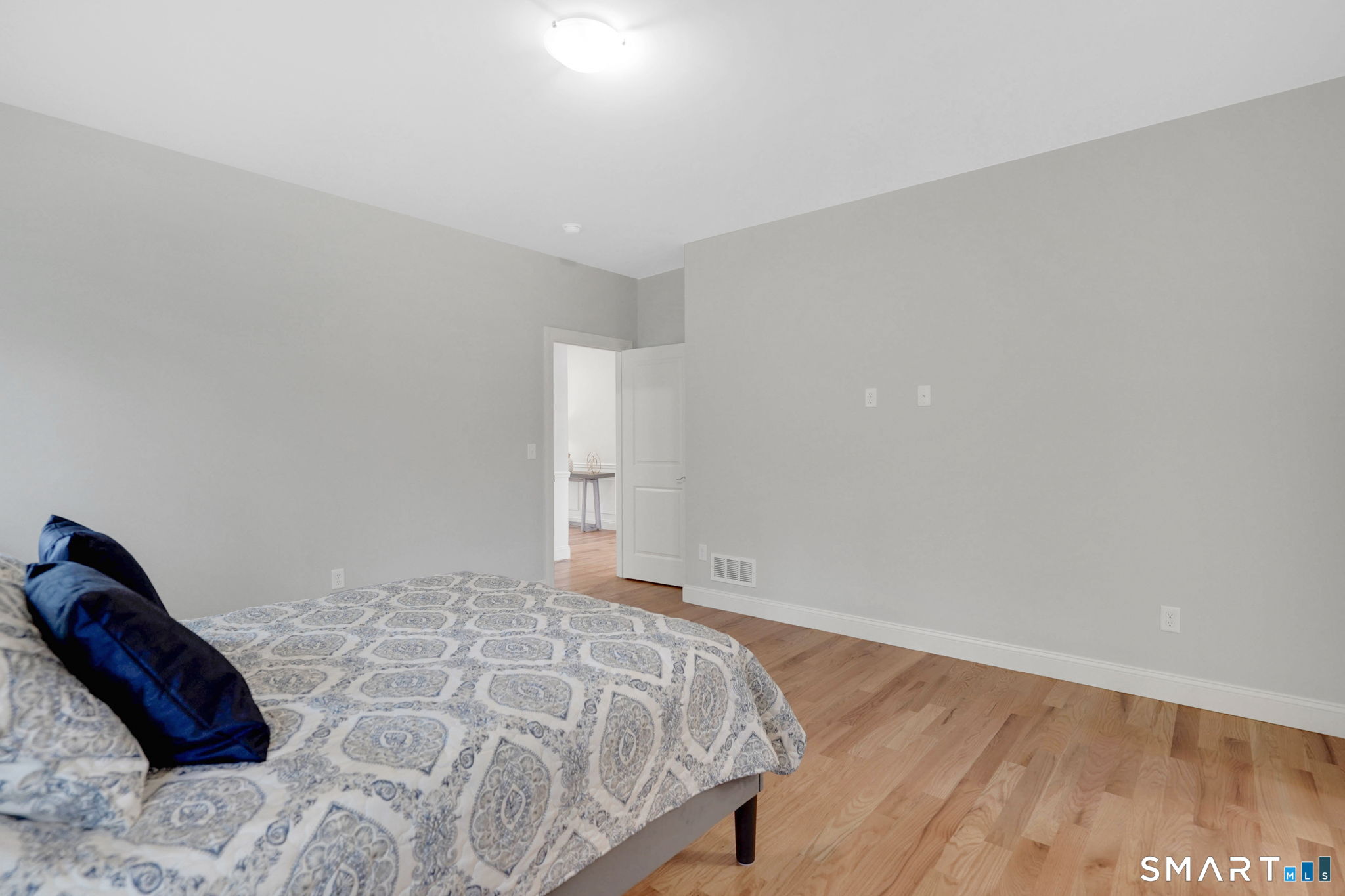 60 Liberty Lane Enfield, CT 06082 - Photo 26 of 38 a bedroom with a bed and a wooden floor