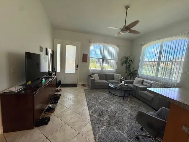 a living room with furniture and a flat screen tv