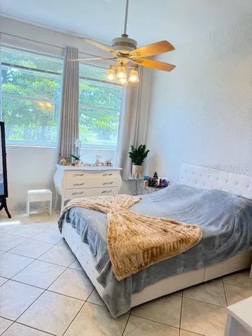 a bed sitting in a bedroom next to a window