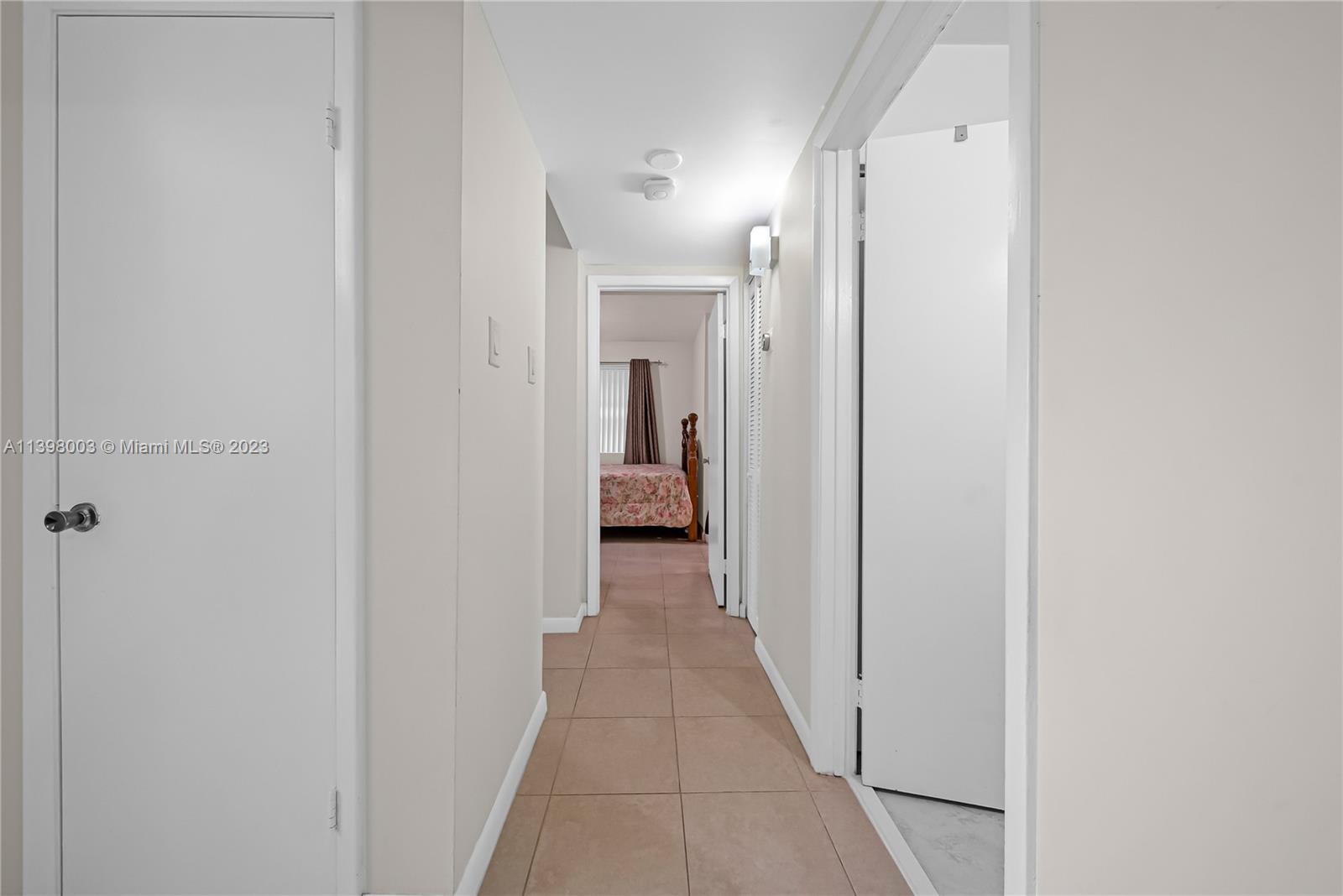 15330 Southwest 106th Terrace, Unit 903 Miami, FL 33196 - Photo 11 of 43 a view of a hallway with a white walls