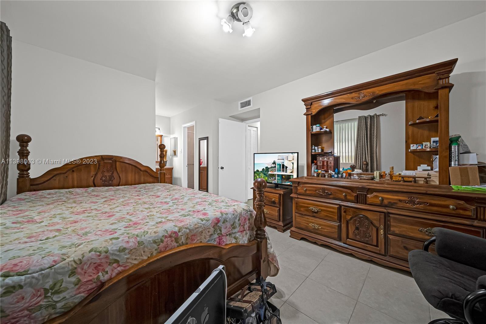 15330 Southwest 106th Terrace, Unit 903 Miami, FL 33196 - Photo 16 of 43 a bedroom with a bed and a large mirror on dresser