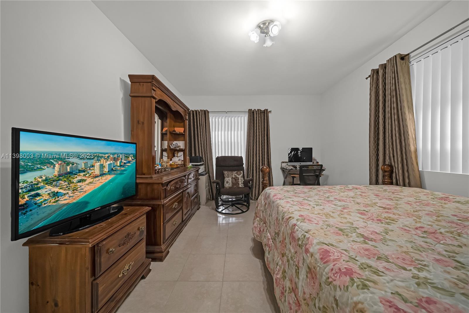 15330 Southwest 106th Terrace, Unit 903 Miami, FL 33196 - Photo 17 of 43 a bedroom with a bed and a flat screen tv