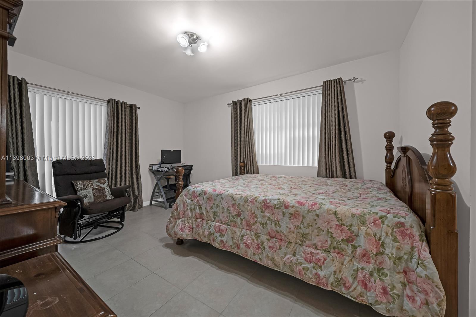 15330 Southwest 106th Terrace, Unit 903 Miami, FL 33196 - Photo 18 of 43 a bedroom with a bed gym equipment and a flat tv screen