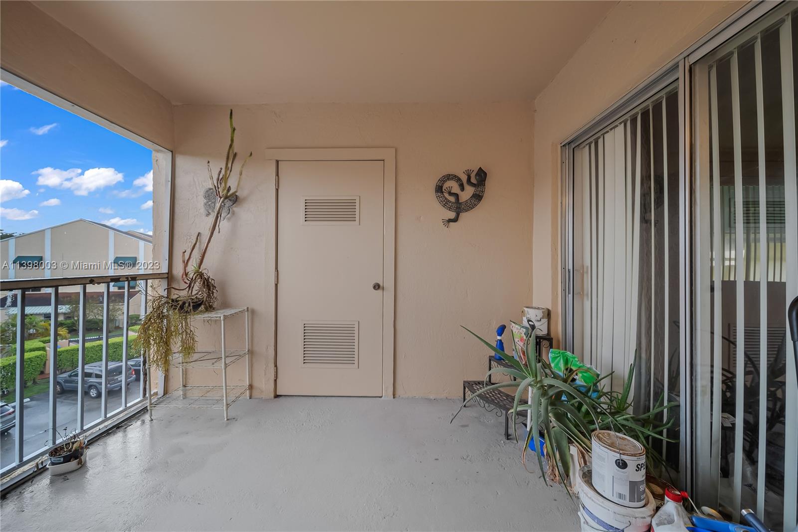 15330 Southwest 106th Terrace, Unit 903 Miami, FL 33196 - Photo 25 of 43 a view of entryway with a floor to ceiling window and potted plants