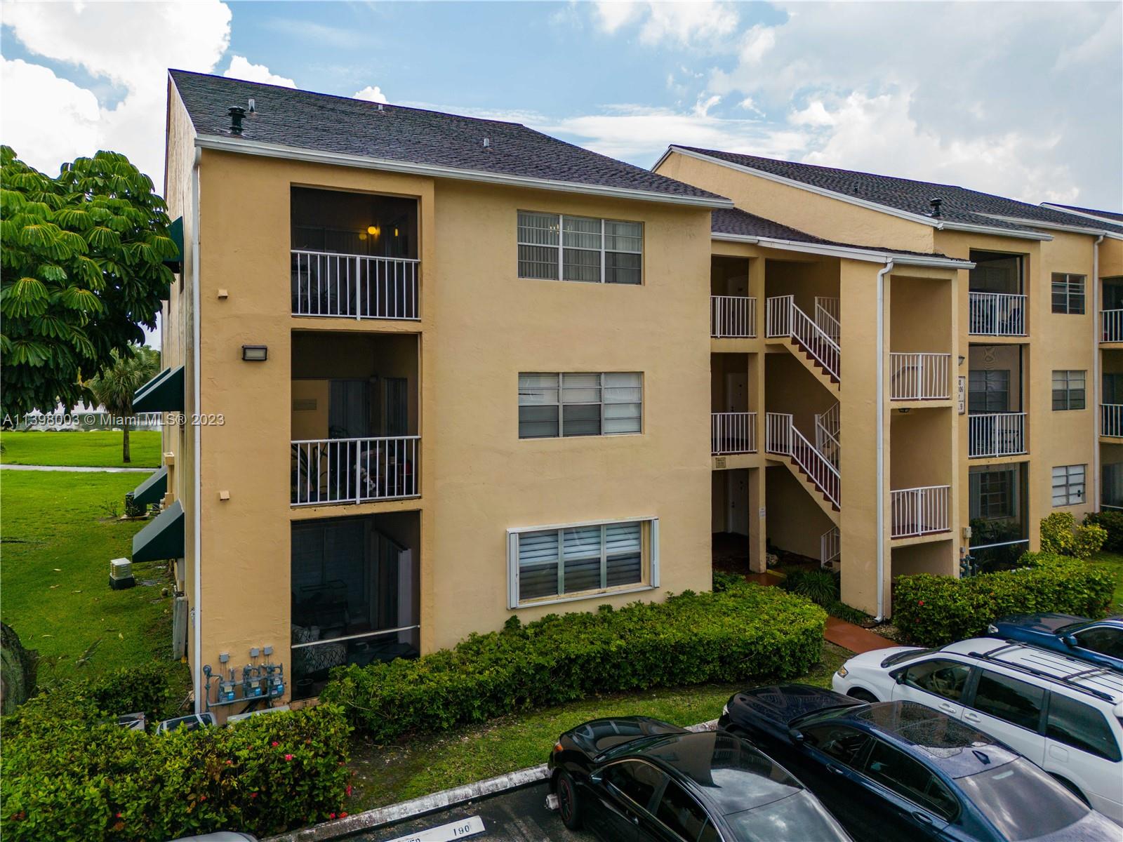 15330 Southwest 106th Terrace, Unit 903 Miami, FL 33196 - Photo 4 of 43 a front view of a house with a yard