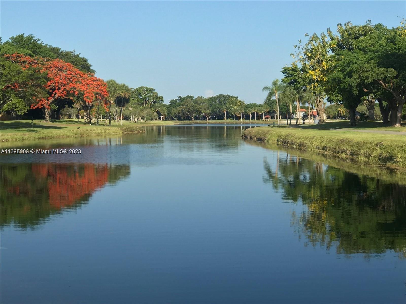 15330 Southwest 106th Terrace, Unit 903 Miami, FL 33196 - Photo 43 of 43 a view of a lake with a house in the background