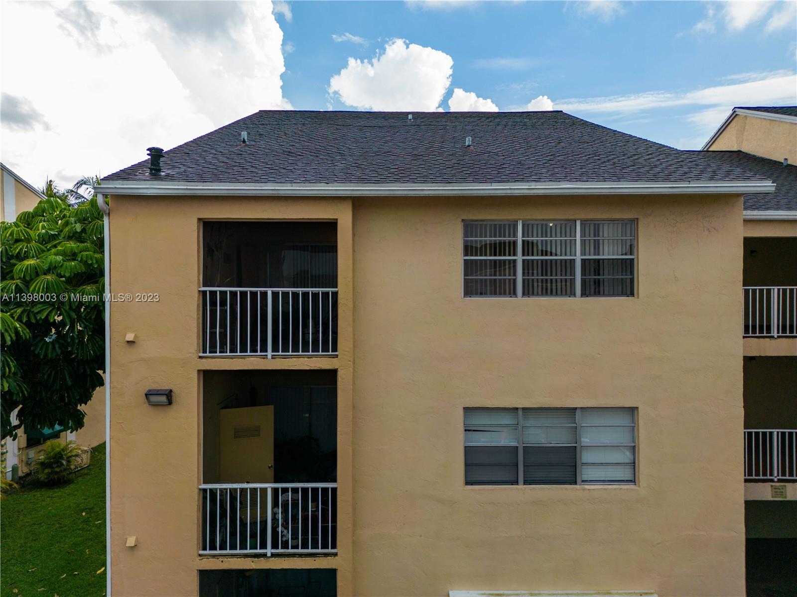 15330 Southwest 106th Terrace, Unit 903 Miami, FL 33196 - Photo 5 of 43 a front view of a house with a yard