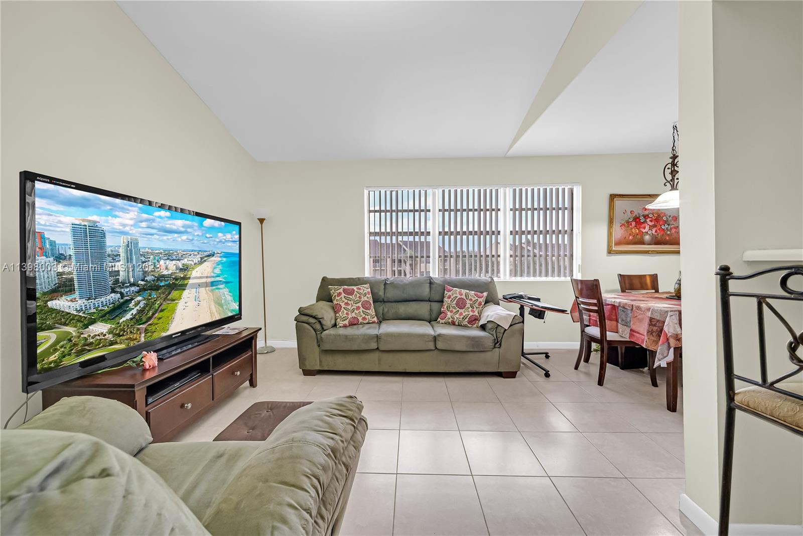 15330 Southwest 106th Terrace, Unit 903 Miami, FL 33196 - Photo 6 of 43 a living room with furniture and a flat screen tv