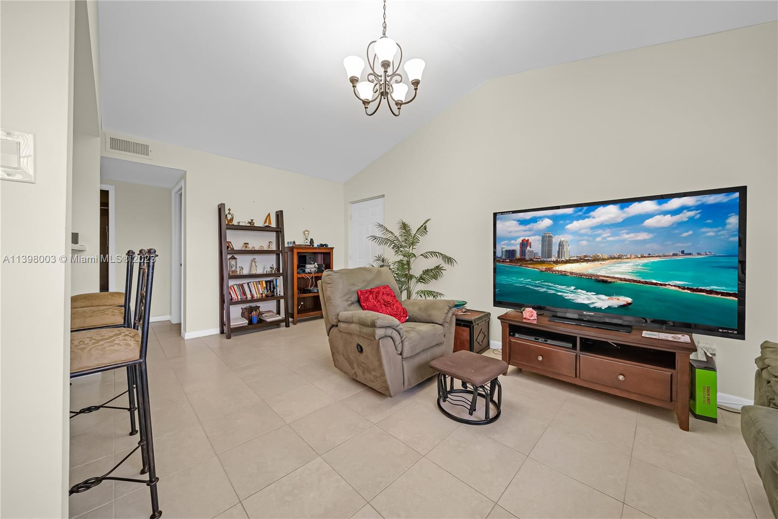 15330 Southwest 106th Terrace, Unit 903 Miami, FL 33196 - Photo 7 of 43 a living room with furniture and a flat screen tv