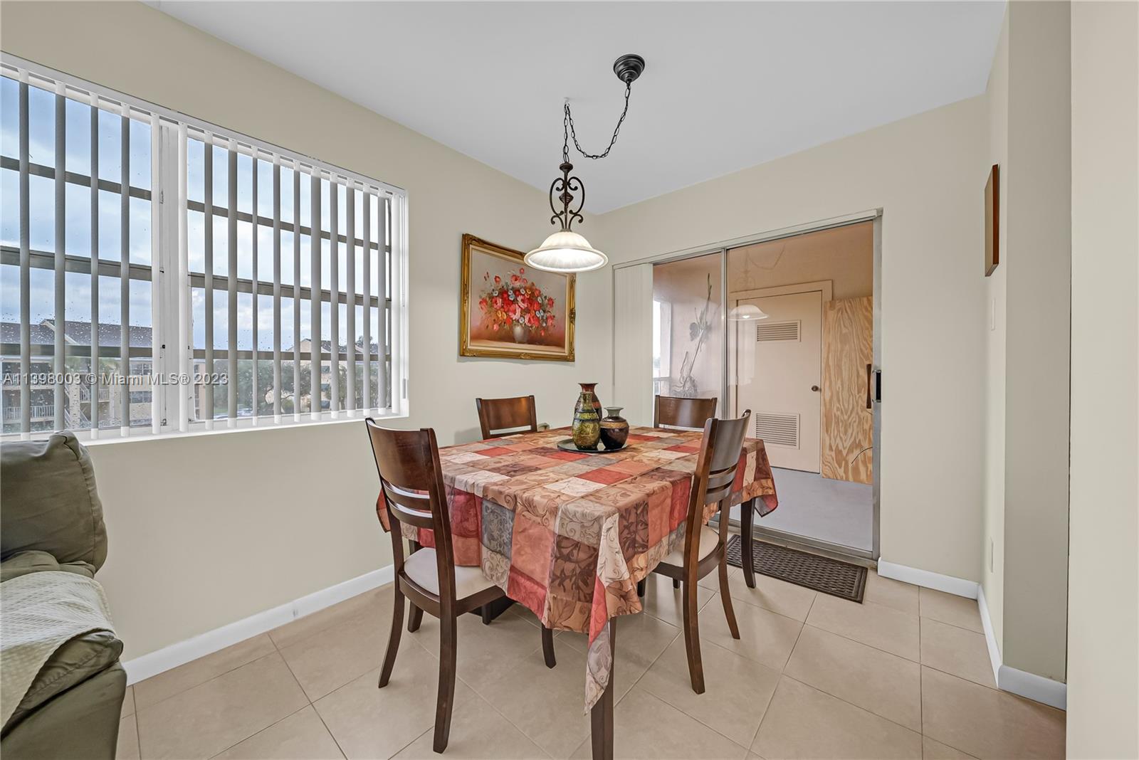 15330 Southwest 106th Terrace, Unit 903 Miami, FL 33196 - Photo 9 of 43 a view of a dining room with furniture window and wooden floor
