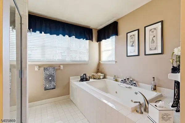 a bathroom with a bathtub a sink and a window