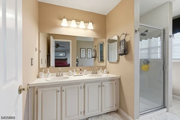 a bathroom with a double vanity sink and a mirror
