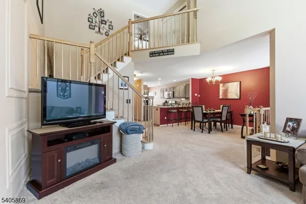 a view of a livingroom with furniture and a flat screen tv