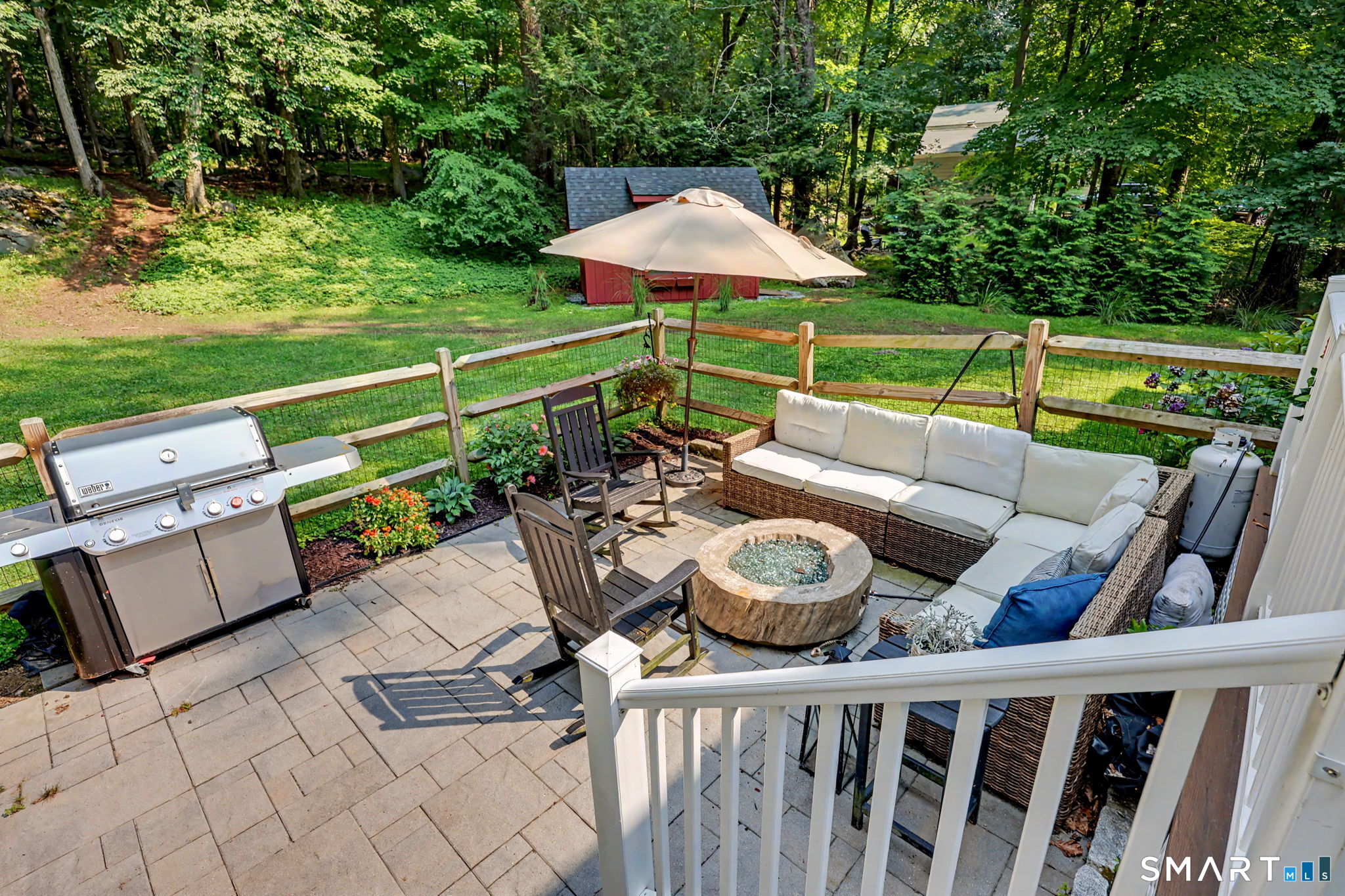241 Mountain Road Wilton, CT 06897 - Photo 27 of 32 Spacious stone patio offers plenty of room for grilling, gathering and relaxing around the fire pit, all overlooking the private backyard.