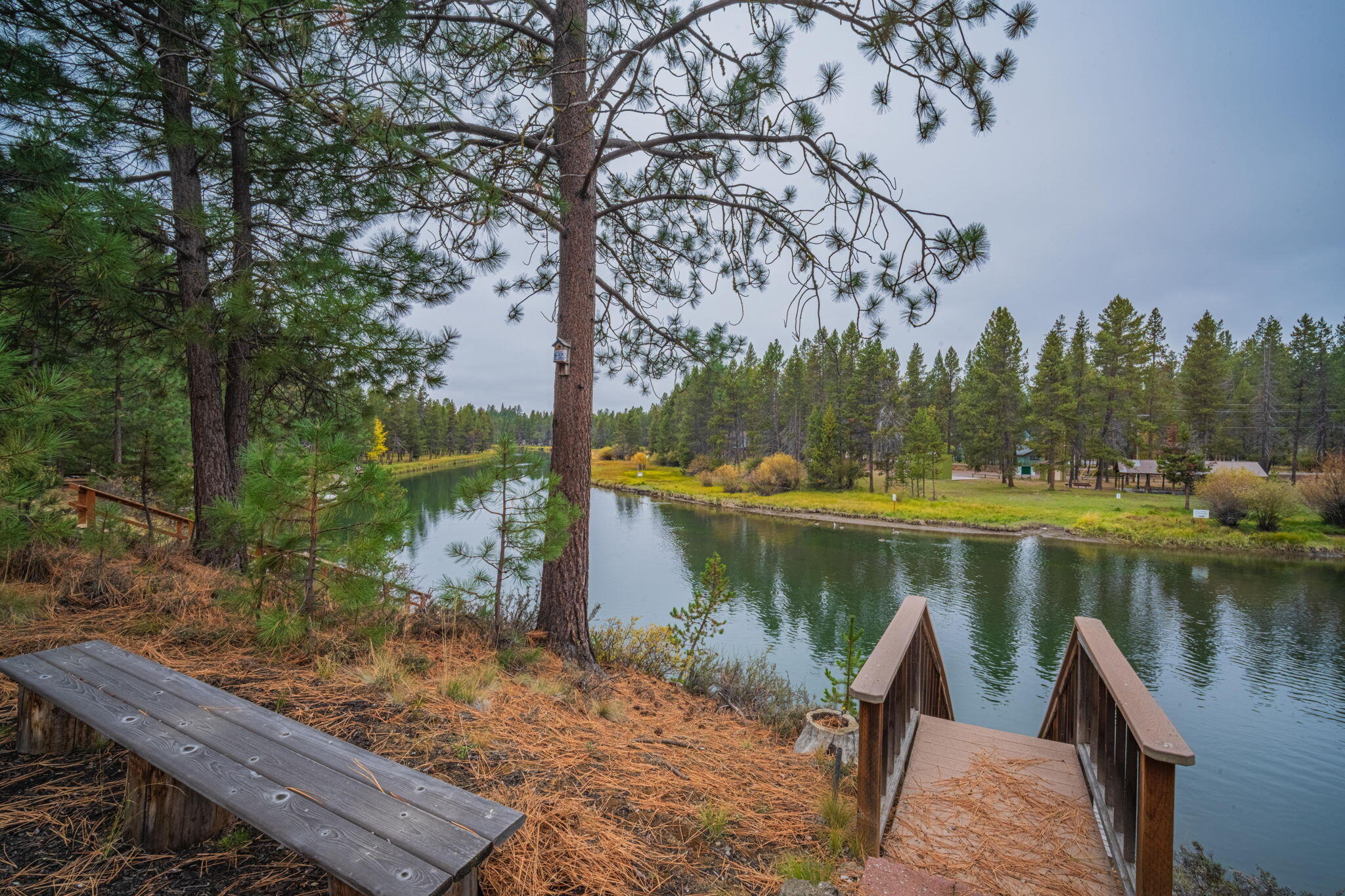 56019 Snow Goose Road Bend, OR 97707 - Photo 7 of 32 a view of a lake with houses in the back