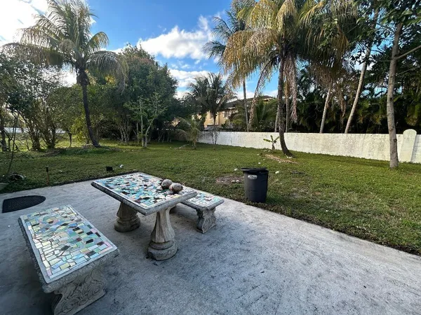 a view of a backyard with a garden and entertaining space