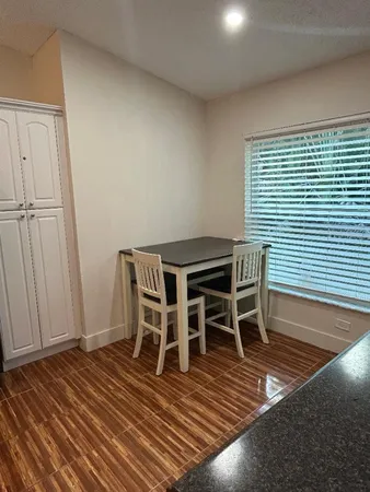 a dining room with furniture and wooden floor