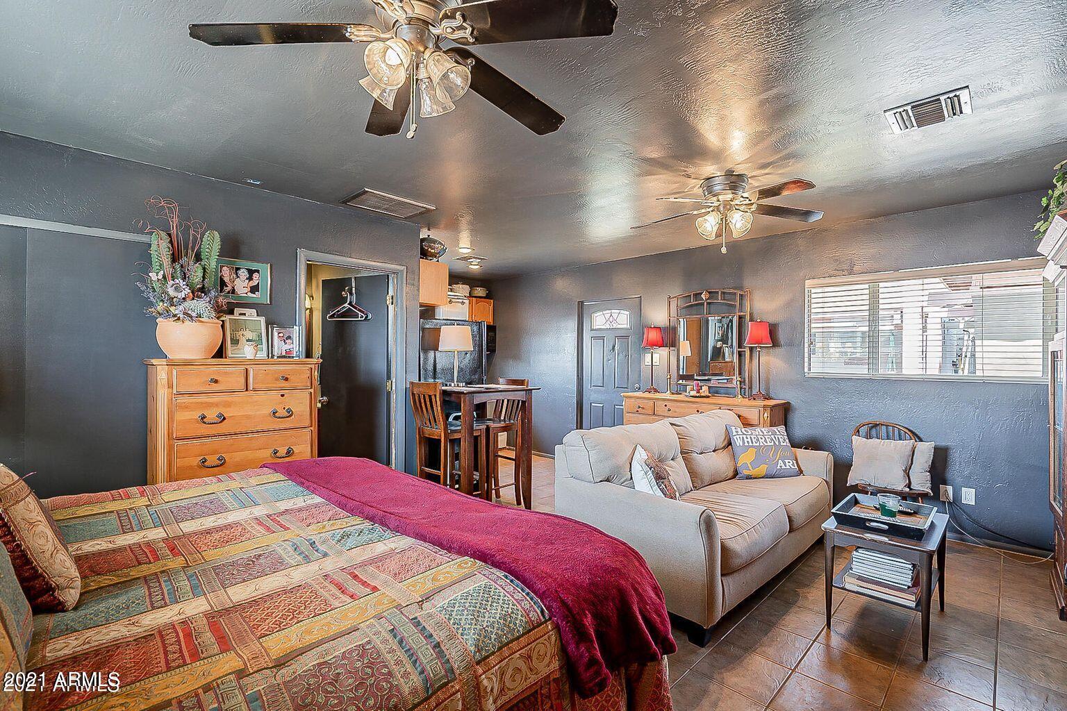 9416 North 3rd Avenue Phoenix, AZ 85021 - Photo 21 of 25 a bedroom with a bed ceiling fan and a closet