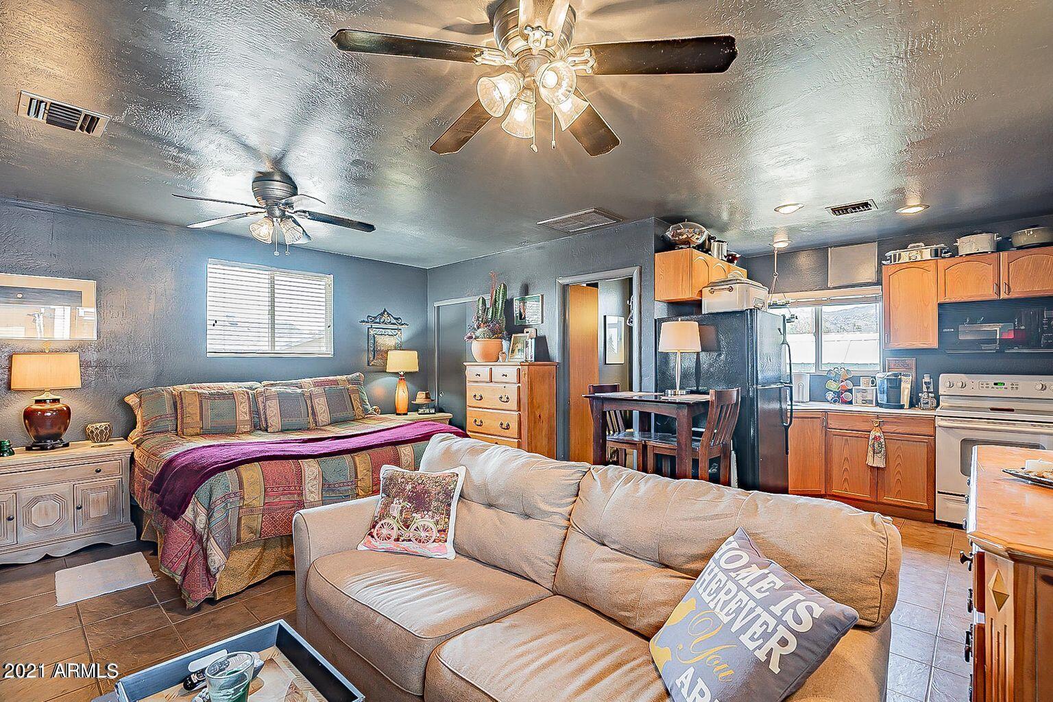 9416 North 3rd Avenue Phoenix, AZ 85021 - Photo 22 of 25 a living room with furniture a ceiling fan and a rug