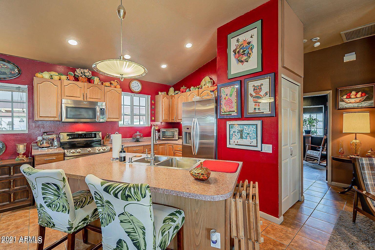 9416 North 3rd Avenue Phoenix, AZ 85021 - Photo 8 of 25 a kitchen with stainless steel appliances dining table and chairs