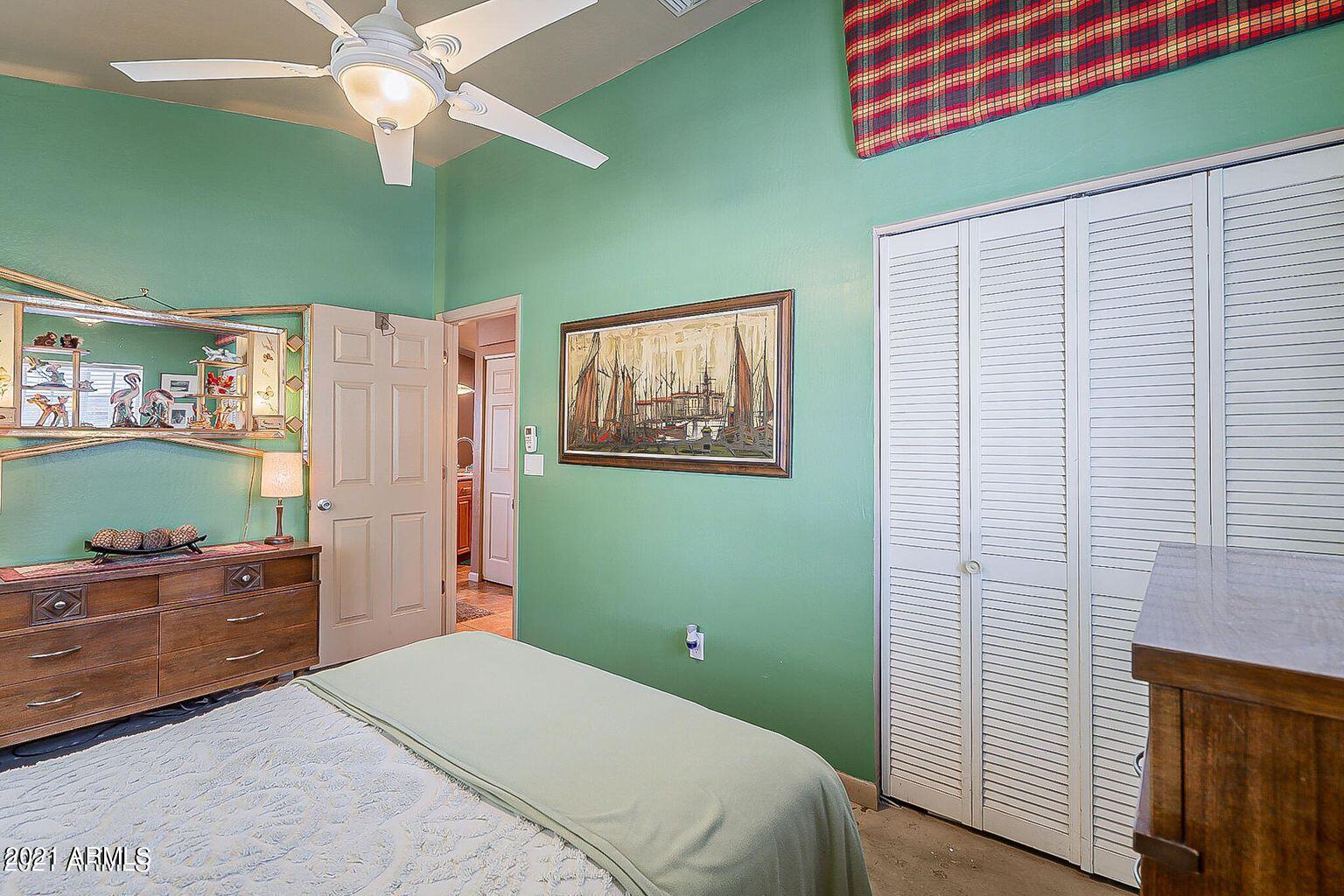 9416 North 3rd Avenue Phoenix, AZ 85021 - Photo 10 of 25 a bedroom with a bed and a chandelier