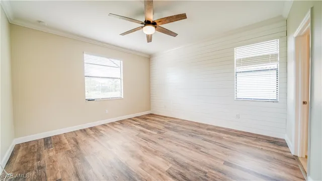 wooden floor in an empty room with a window