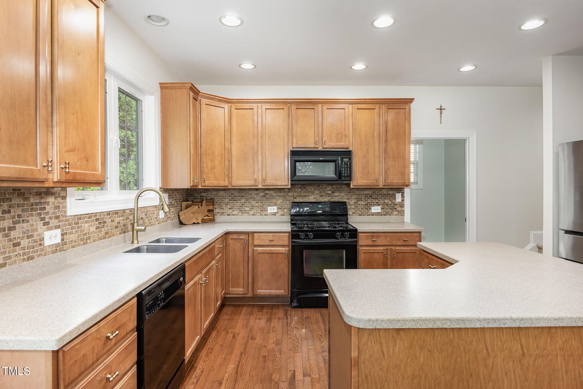 1603 Timber Wolf Drive Durham, NC 27713 - Photo 12 of 41 a kitchen with kitchen island granite countertop a sink a counter top space stainless steel appliances and cabinets