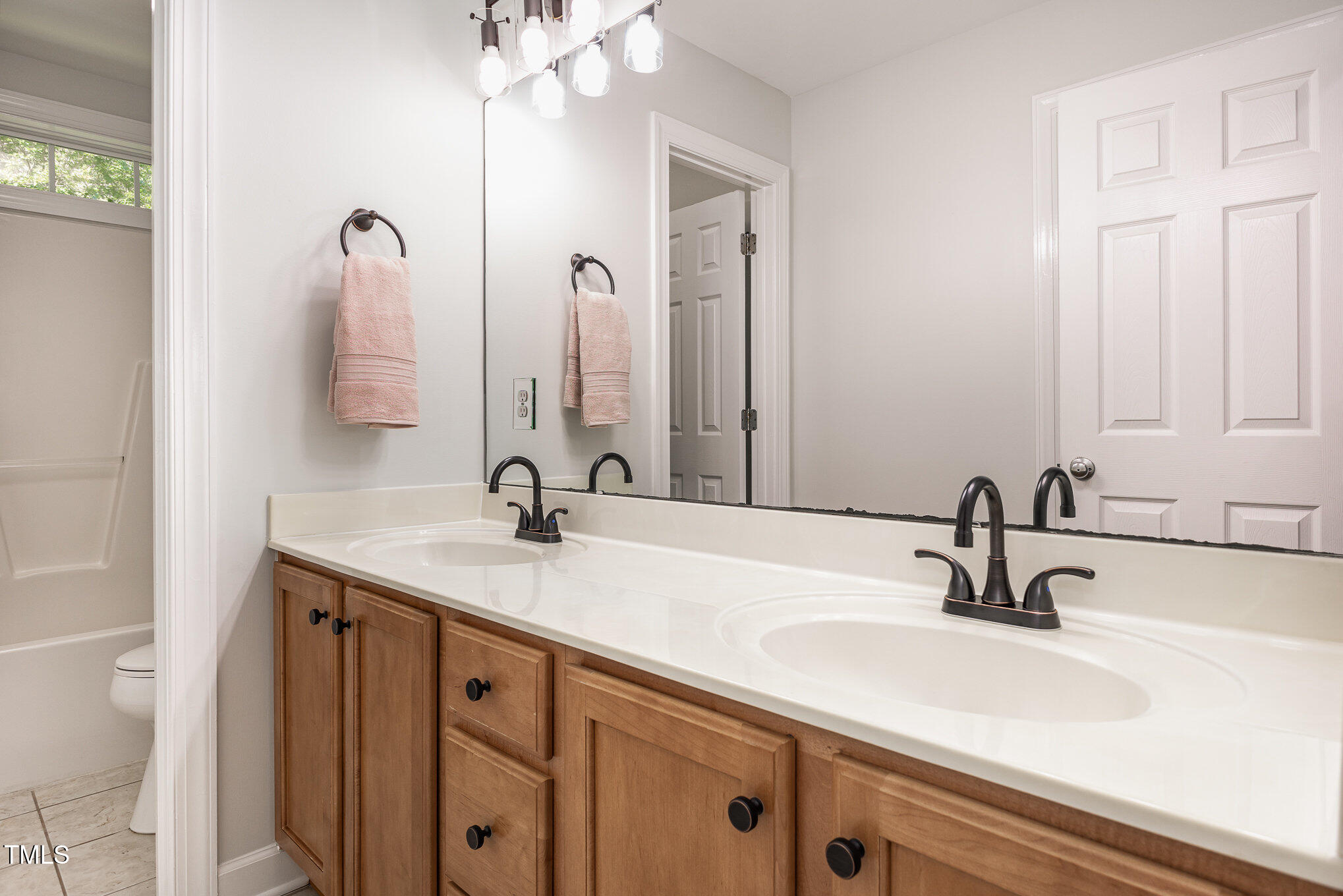 1603 Timber Wolf Drive Durham, NC 27713 - Photo 29 of 41 a bathroom with double sink and a mirror