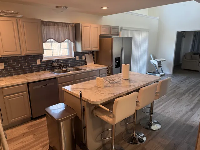 a kitchen with a table chairs stove and refrigerator