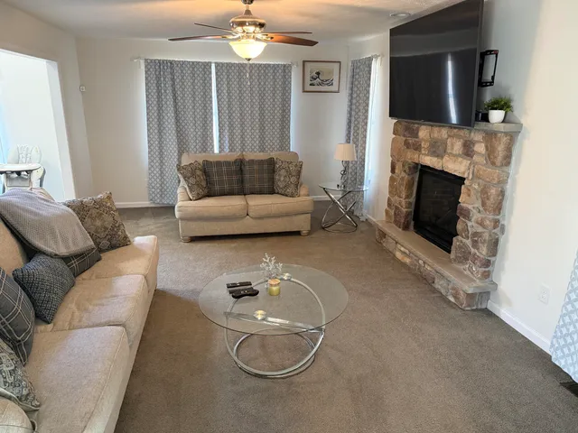 a living room with furniture and a fireplace