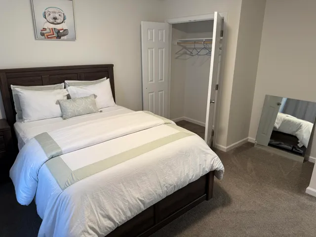 a bedroom with a bed and a mirror