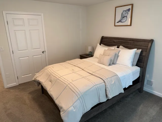 a bed sitting in a bedroom next to a window