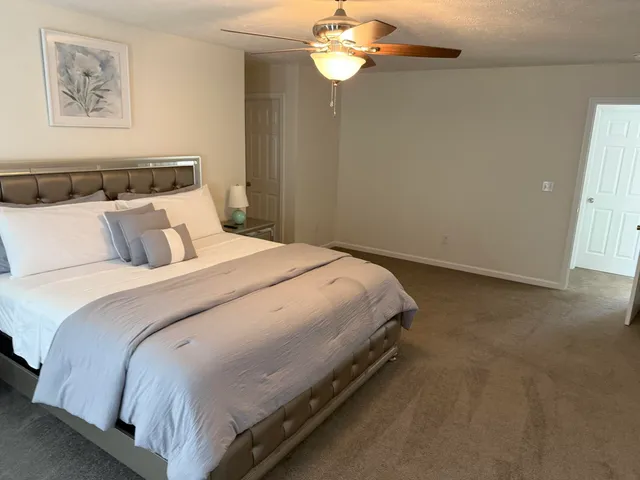 a bedroom with a bed and a chandelier