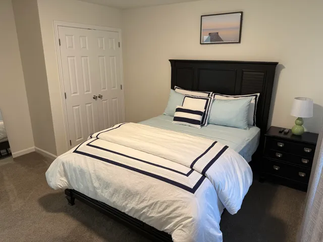 a bedroom with a bed and a night stand