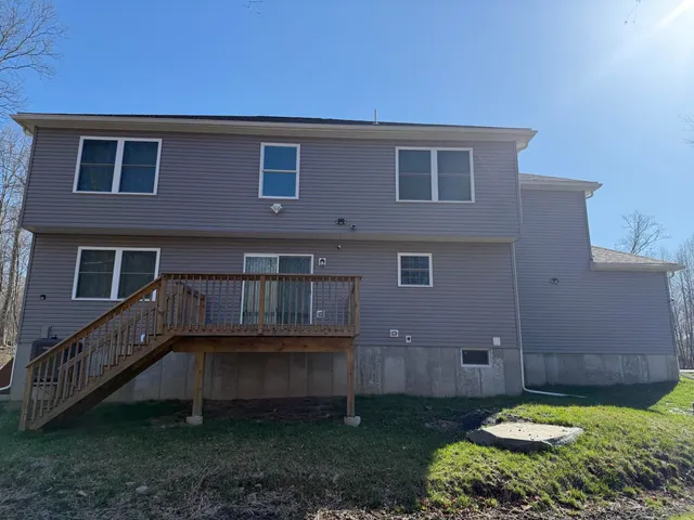 a backyard of a house with barbeque oven and outdoor seating