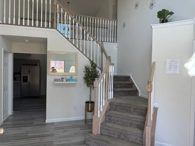 a view of entryway and hall with wooden floor