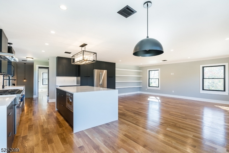 76 Burnet Road, Unit 2 Florham Park, NJ 07940 - Photo 11 of 24 a kitchen with stainless steel appliances granite countertop a stove and a wooden floor
