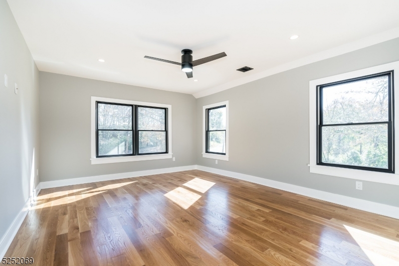 76 Burnet Road, Unit 2 Florham Park, NJ 07940 - Photo 12 of 24 a view of an empty room with a window and wooden floor