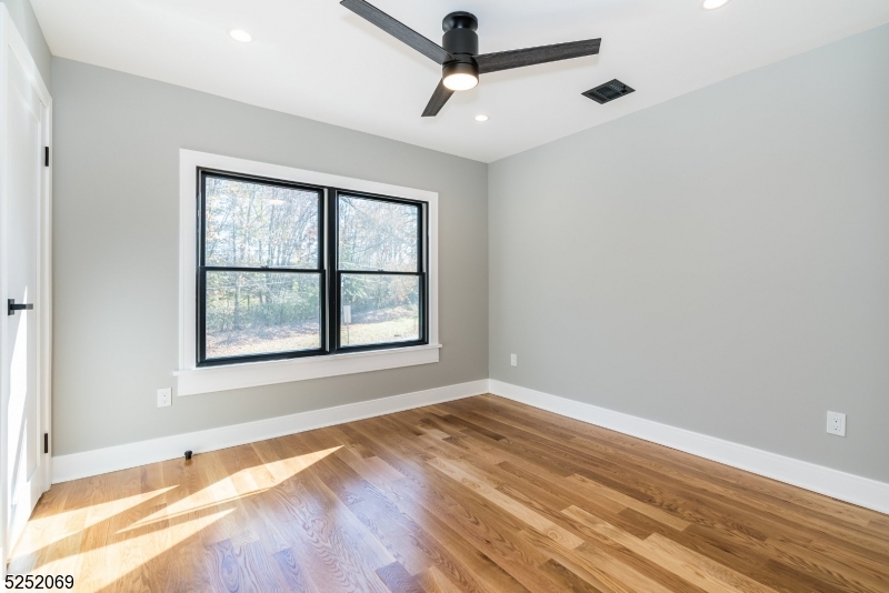 76 Burnet Road, Unit 2 Florham Park, NJ 07940 - Photo 14 of 24 an empty room with a window and a ceiling fan