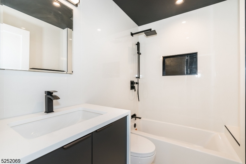 76 Burnet Road, Unit 2 Florham Park, NJ 07940 - Photo 15 of 24 a bathroom with a sink a toilet and a bathtub