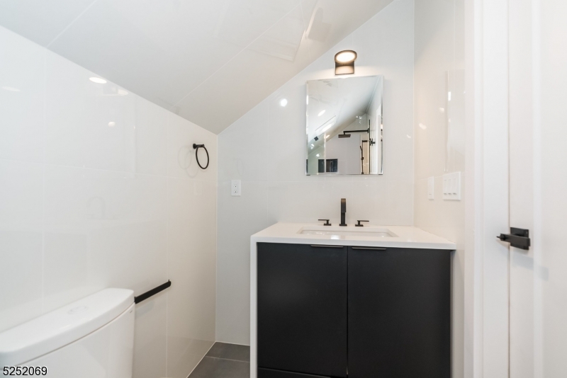 76 Burnet Road, Unit 2 Florham Park, NJ 07940 - Photo 19 of 24 a bathroom with a sink a toilet and mirror