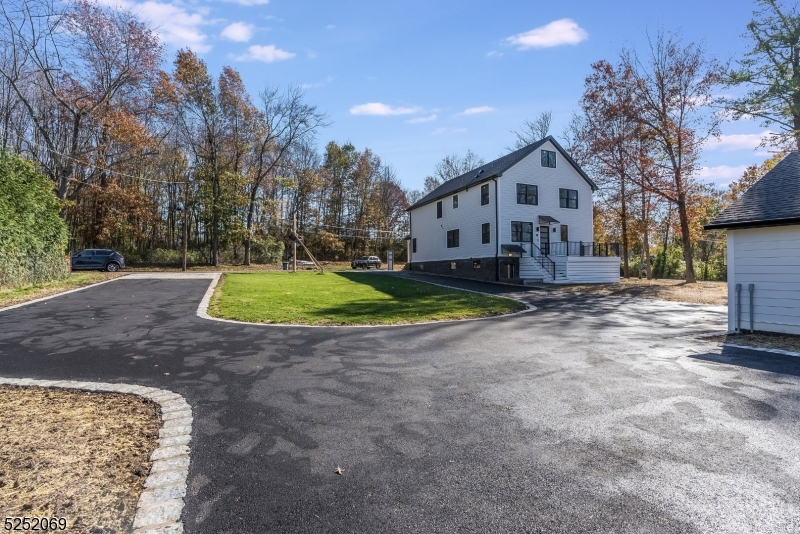 76 Burnet Road, Unit 2 Florham Park, NJ 07940 - Photo 22 of 24 a front view of a house with a yard and garage