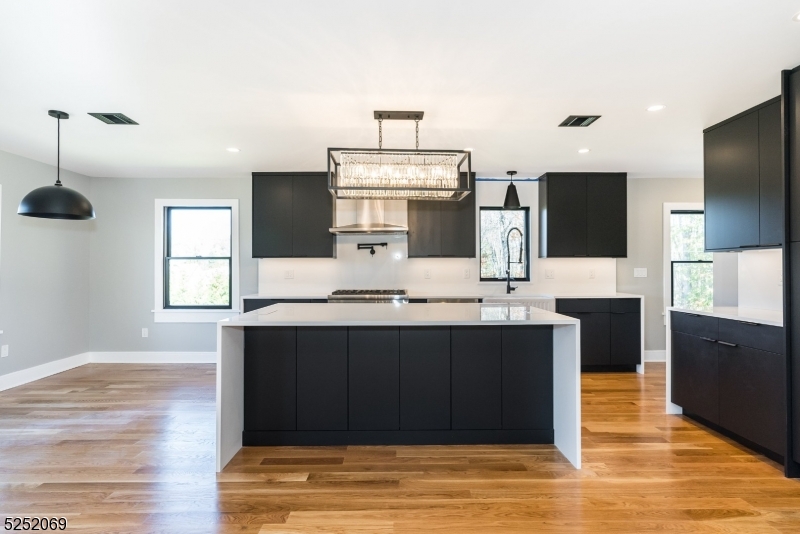 76 Burnet Road, Unit 2 Florham Park, NJ 07940 - Photo 7 of 24 a view of kitchen with stainless steel appliances wooden floor and chandelier